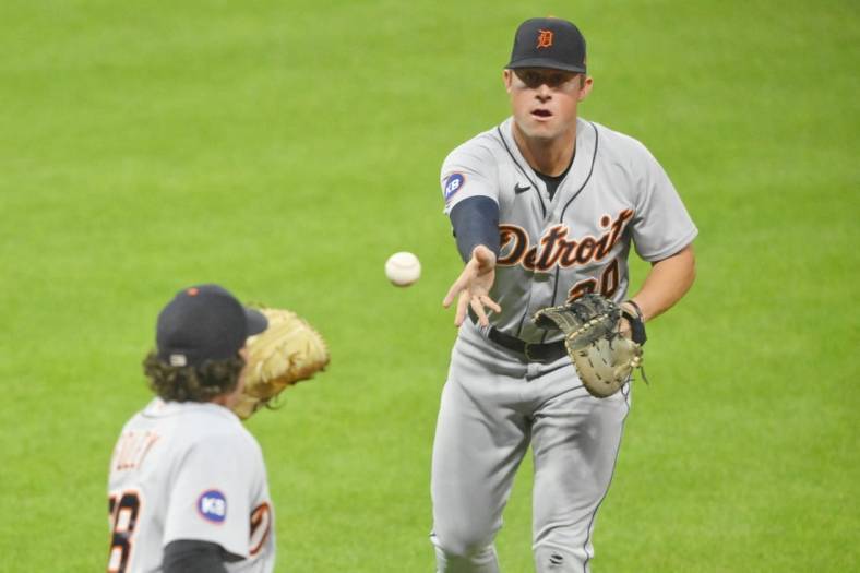Jul 14, 2022; Cleveland, Ohio, USA; Detroit Tigers first baseman Spencer Torkelson (20) tosses the ball to relief pitcher Jason Foley (68) in the seventh inning against the Cleveland Guardians at Progressive Field. Mandatory Credit: David Richard-USA TODAY Sports