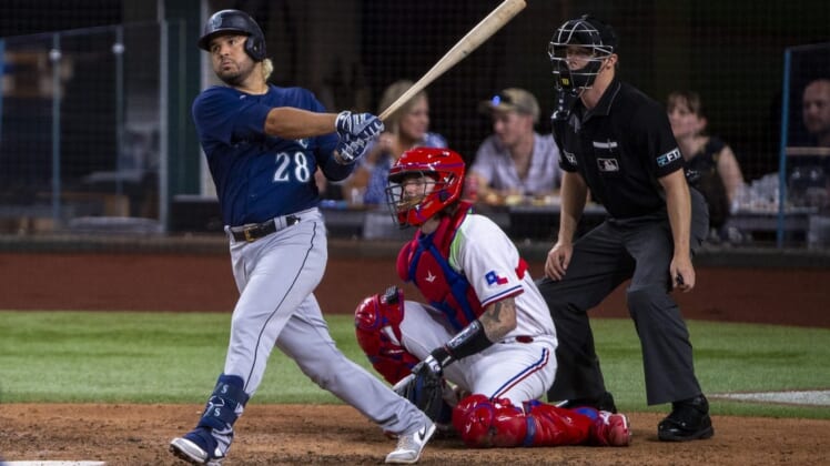 Jul 14, 2022; Arlington, Texas, USA; Seattle Mariners third baseman Eugenio Suarez (28) hits a single and drives in two runs against the Texas Rangers during the seventh inning at Globe Life Field. Mandatory Credit: Jerome Miron-USA TODAY Sports