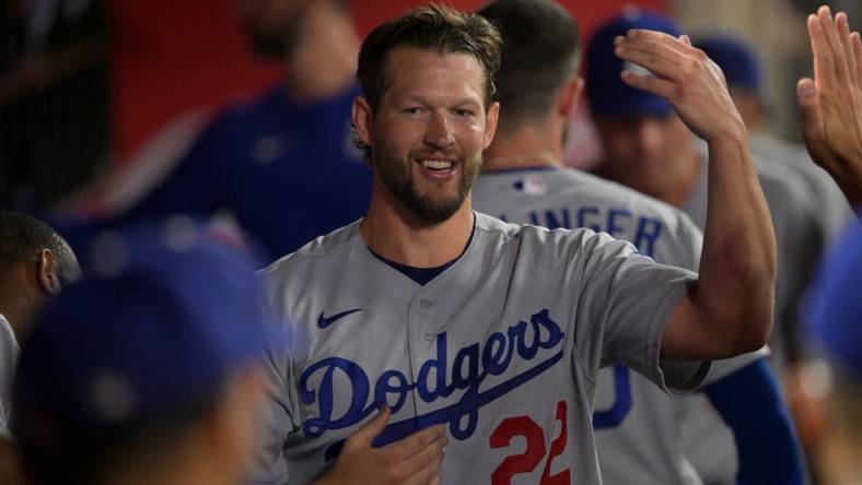 Jul 15, 2022; Anaheim, California, USA;  Los Angeles Dodgers starting pitcher Clayton Kershaw (22) is congratulated in the dugout following the eighth inning against the Los Angeles Angels at Angel Stadium. Mandatory Credit: Jayne Kamin-Oncea-USA TODAY Sports