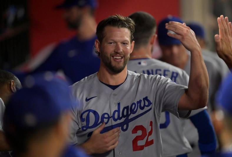 Jul 15, 2022; Anaheim, California, USA;  Los Angeles Dodgers starting pitcher Clayton Kershaw (22) is congratulated in the dugout following the eighth inning against the Los Angeles Angels at Angel Stadium. Mandatory Credit: Jayne Kamin-Oncea-USA TODAY Sports
