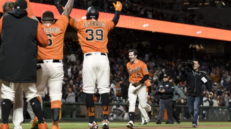 Jul 15, 2022; San Francisco, California, USA;  San Francisco Giants right fielder Mike Yastrzemski (5) celebrates with teammates after he hit a grand slam for a walkoff win against the Milwaukee Brewers  at Oracle Park. Mandatory Credit: John Hefti-USA TODAY Sports