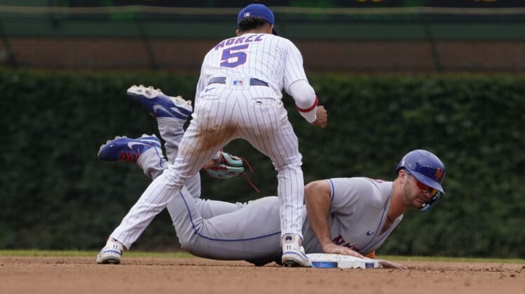 Jul 16, 2022; Chicago, Illinois, USA; New York Mets designated hitter Pete Alonso (20) slides back into second base safely on a pick off attempt as Chicago Cubs second baseman Christopher Morel (5) makes a late tag during the fourth inning in game one of a doubleheader at Wrigley Field. Mandatory Credit: David Banks-USA TODAY Sports