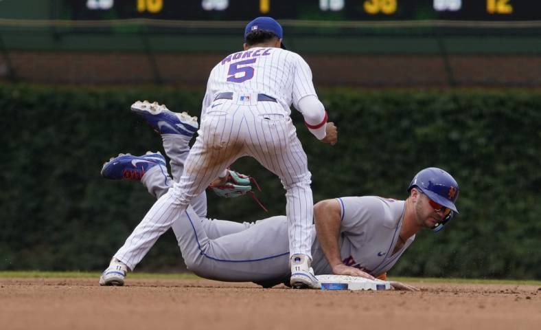 Jul 16, 2022; Chicago, Illinois, USA; New York Mets designated hitter Pete Alonso (20) slides back into second base safely on a pick off attempt as Chicago Cubs second baseman Christopher Morel (5) makes a late tag during the fourth inning in game one of a doubleheader at Wrigley Field. Mandatory Credit: David Banks-USA TODAY Sports