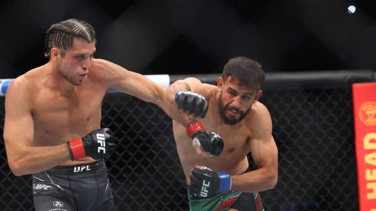 Jul 16, 2022; Elmont, New York, USA; Brian Ortega (red gloves) fights Yair Rodriguez (blue gloves) during UFC Fight Night at UBS Arena. Mandatory Credit: Ed Mulholland-USA TODAY Sports