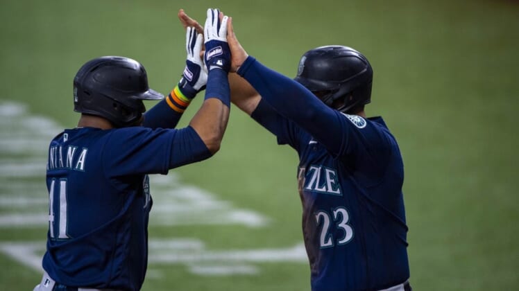 Jul 16, 2022; Arlington, Texas, USA; Seattle Mariners designated hitter Carlos Santana (41) and first baseman Ty France (23) celebrate the two run home run hit by Santana against the Texas Rangers during the third inning at Globe Life Field. Mandatory Credit: Jerome Miron-USA TODAY Sports