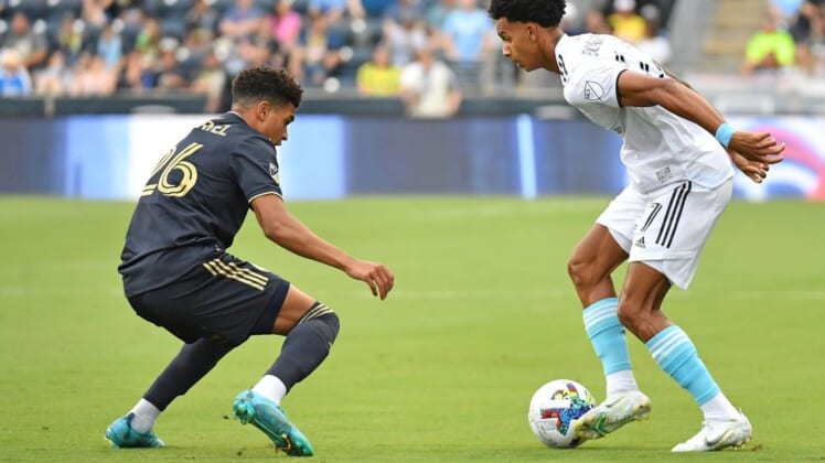 Jul 16, 2022; Chester, Pennsylvania, USA; New England Revolution midfielder Dylan Borrero (27) is defended by Philadelphia Union defender Nathan Harriel (26) during the first half at Subaru Park. Mandatory Credit: Eric Hartline-USA TODAY Sports