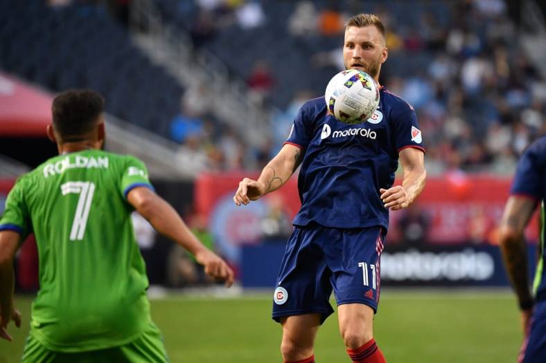 Jul 16, 2022; Chicago, Illinois, USA; Chicago Fire FC forward Kacper Przybylko (11) settles a throw against the Seattle Sounders in in the first half at Soldier Field. Mandatory Credit: Jamie Sabau-USA TODAY Sports