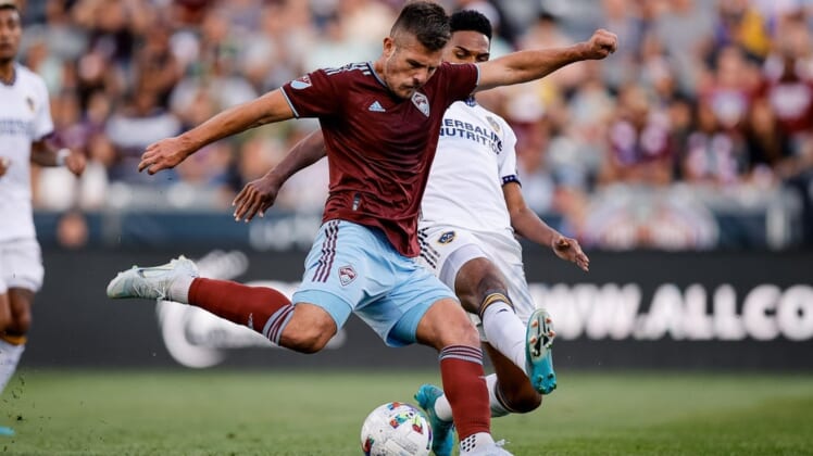 Jul 16, 2022; Commerce City, Colorado, USA; Colorado Rapids midfielder Diego Rubio (11) scores on a shot as LA Galaxy midfielder Rayan Raveloson (6) defends in the first half at Dick's Sporting Goods Park. Mandatory Credit: Isaiah J. Downing-USA TODAY Sports