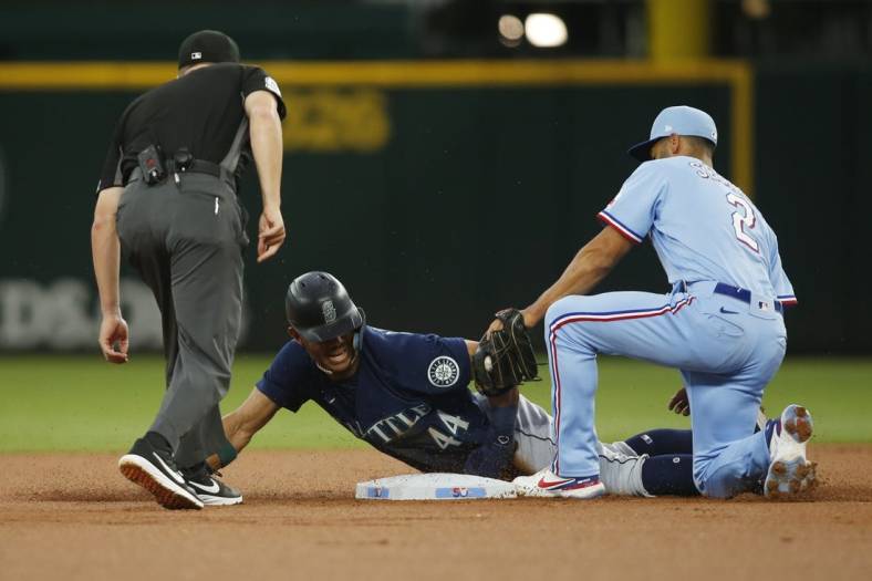 Jul 17, 2022; Arlington, Texas, USA;  Texas Rangers second baseman Marcus Semien (2) tags out Seattle Mariners center fielder Julio Rodriguez (44) as he attempts to steal second base in the first inning at Globe Life Field. Mandatory Credit: Tim Heitman-USA TODAY Sports