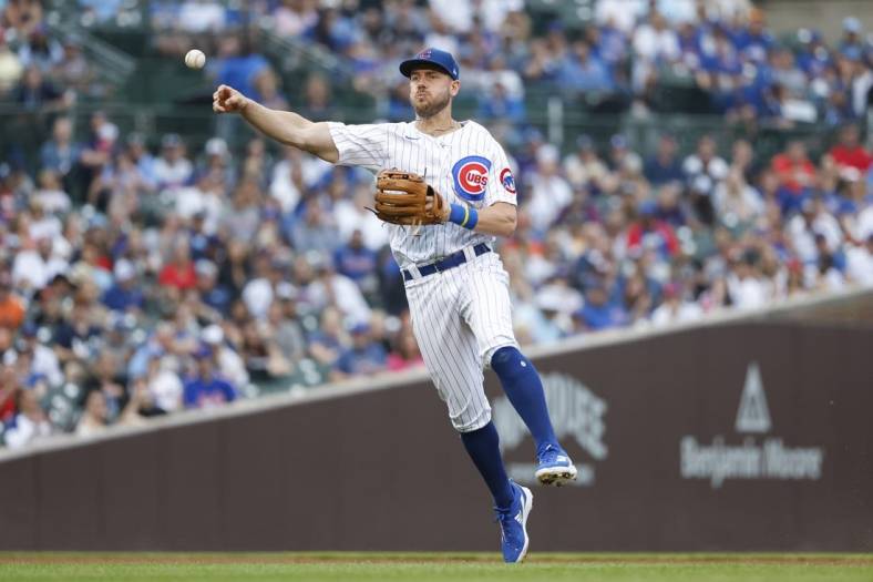 Jul 17, 2022; Chicago, Illinois, USA; Chicago Cubs third baseman Patrick Wisdom (16) throws to first base for a New York Mets out during the fourth inning at Wrigley Field. Mandatory Credit: Kamil Krzaczynski-USA TODAY Sports