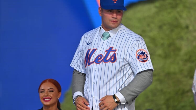 Jul 17, 2022; Los Angeles, CA, USA;  Kevin Parada puts on a jersey after he was selected by the New York Mets as the 11th player in the MLB draft at XBox Plaza at LA Live. Mandatory Credit: Jayne Kamin-Oncea-USA TODAY Sports