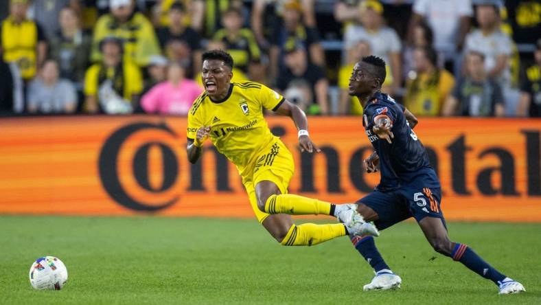 Jul 17, 2022; Columbus, Ohio, USA; Columbus Crew midfielder Luis Diaz (12) is fouled by FC Cincinnati midfielder Obinna Nwobodo (5) in the first half at Lower.com Field. Mandatory Credit: Trevor Ruszkowski-USA TODAY Sports