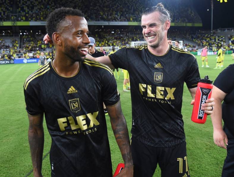 Jul 17, 2022; Nashville, Tennessee, USA; Los Angeles FC forward Gareth Bale (11) celebrates with midfielder Kellyn Acosta (23) after a win against the Nashville SC at Geodis Park. Mandatory Credit: Christopher Hanewinckel-USA TODAY Sports