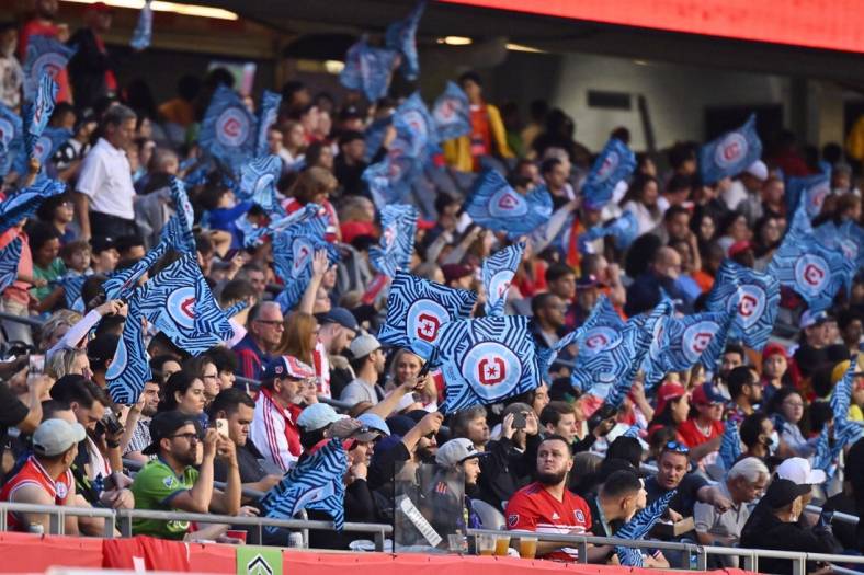 Jul 16, 2022; Chicago, Illinois, USA; Chicago Fire FC fans wave their flags during a match against the Seattle Sounders at Soldier Field. Chicago defeated Seattle 1-0. Mandatory Credit: Jamie Sabau-USA TODAY Sports