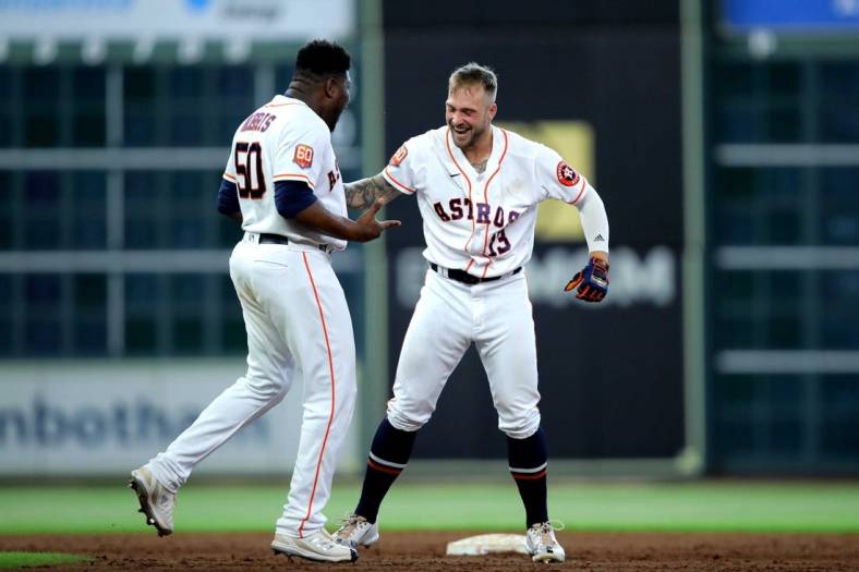 Jul 21, 2022; Houston, Texas, USA; Houston Astros pinch hitter J.J. Matijevic (13, right) is congratulated by Houston Astros relief pitcher Hector Neris (50, left) after hitting a walkoff RBI single against the New York Yankees during the ninth inning at Minute Maid Park. Mandatory Credit: Erik Williams-USA TODAY Sports
