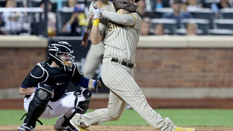 Jul 22, 2022; New York City, New York, USA; San Diego Padres first baseman Eric Hosmer (30) follows through on a two run home run against the New York Mets during the fourth inning at Citi Field. Mandatory Credit: Brad Penner-USA TODAY Sports