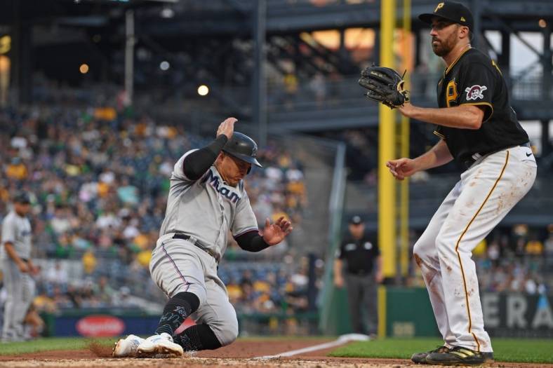 Jul 22, 2022; Pittsburgh, Pennsylvania, USA; Miami Marlins right fielder Avisail Garcia (24) scores a run on a wild pitch by Pittsburgh Pirates starting pitcher Zach Thompson (39) during the fourth inning at PNC Park. Mandatory Credit: David Dermer-USA TODAY Sports