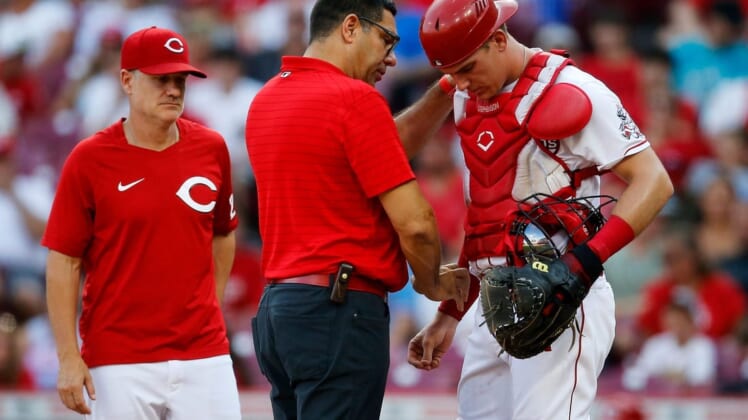 Cincinnati Reds catcher Tyler Stephenson (37) is examined by team trainer Tomas Vera after being hit in the arm by a foul ball in the first inning of the MLB National League game between the Cincinnati Reds and the St. Louis Cardinals at Great American Ball Park in downtown Cincinnati on Friday, July 22, 2022.

St Louis Cardinals At Cincinnati Reds