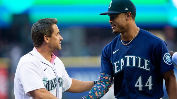 Jul 22, 2022; Seattle, Washington, USA;  Former Seattle Mariners player Bret Boone shakes hands with Seattle Mariners center fielder Julio Rodriguez (44) after the ceremonial first pitch before the game against the Houston Astros at T-Mobile Park. Mandatory Credit: Lindsey Wasson-USA TODAY Sports