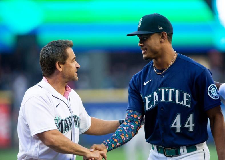 Jul 22, 2022; Seattle, Washington, USA;  Former Seattle Mariners player Bret Boone shakes hands with Seattle Mariners center fielder Julio Rodriguez (44) after the ceremonial first pitch before the game against the Houston Astros at T-Mobile Park. Mandatory Credit: Lindsey Wasson-USA TODAY Sports