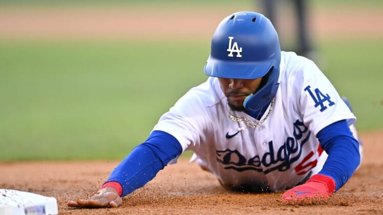 Jul 22, 2022; Los Angeles, California, USA;  Los Angeles Dodgers right fielder Mookie Betts (50) dives back to first on a pick off attempt in the first inning against the San Francisco Giants at Dodger Stadium. Mandatory Credit: Jayne Kamin-Oncea-USA TODAY Sports