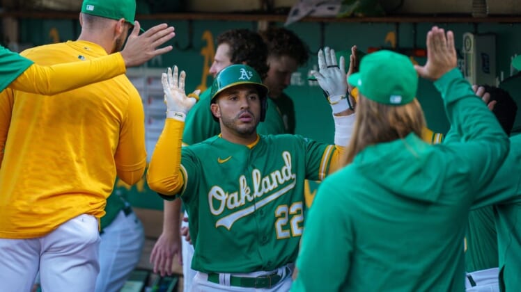 Jul 22, 2022; Oakland, California, USA;  Oakland Athletics right fielder Ramon Laureano (22) celebrates with teammate in the dugout after the home run during the fifth inning against the Texas Rangers at RingCentral Coliseum. Mandatory Credit: Neville E. Guard-USA TODAY Sports