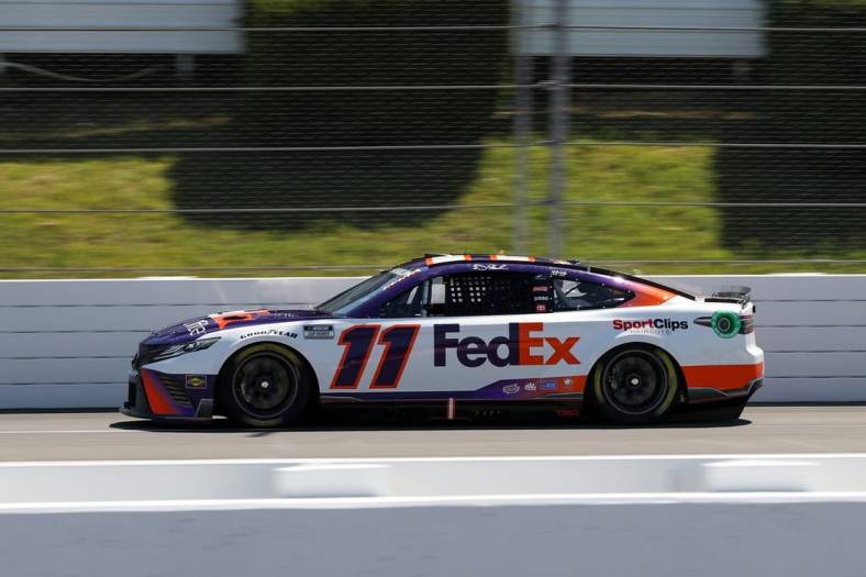 Jul 23, 2022; Long Pond, Pennsylvania, USA; NASCAR Cup Series driver Denny Hamlin (11) during practice and qualifying for the M&Ms Fan Appreciation 400 at Pocono Raceway. Mandatory Credit: Matthew OHaren-USA TODAY Sports