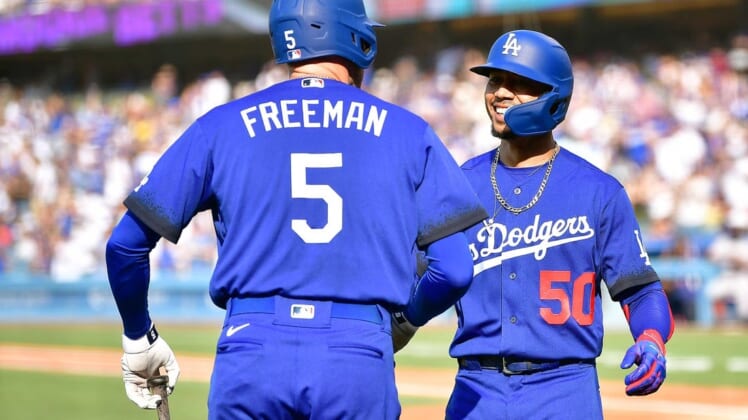 Jul 23, 2022; Los Angeles, California, USA; Los Angeles Dodgers right fielder Mookie Betts (50) is greeted by first baseman Freddie Freeman (5) after hitting a solo home run against the San Francisco Giants during the third inning at Dodger Stadium. Mandatory Credit: Gary A. Vasquez-USA TODAY Sports