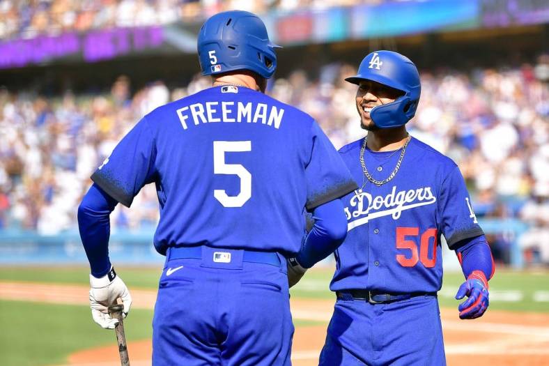 Jul 23, 2022; Los Angeles, California, USA; Los Angeles Dodgers right fielder Mookie Betts (50) is greeted by first baseman Freddie Freeman (5) after hitting a solo home run against the San Francisco Giants during the third inning at Dodger Stadium. Mandatory Credit: Gary A. Vasquez-USA TODAY Sports