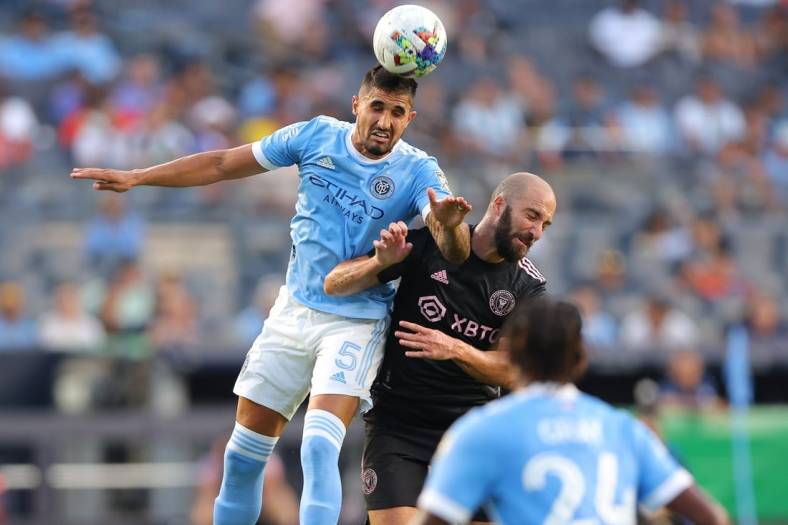 Jul 23, 2022; New York, New York, USA; New York City FC defender Thiago Martins (5) battles for the ball against Inter Miami CF forward Gonzalo Higuain (10) during the first half at Yankee Stadium. Mandatory Credit: Vincent Carchietta-USA TODAY Sports