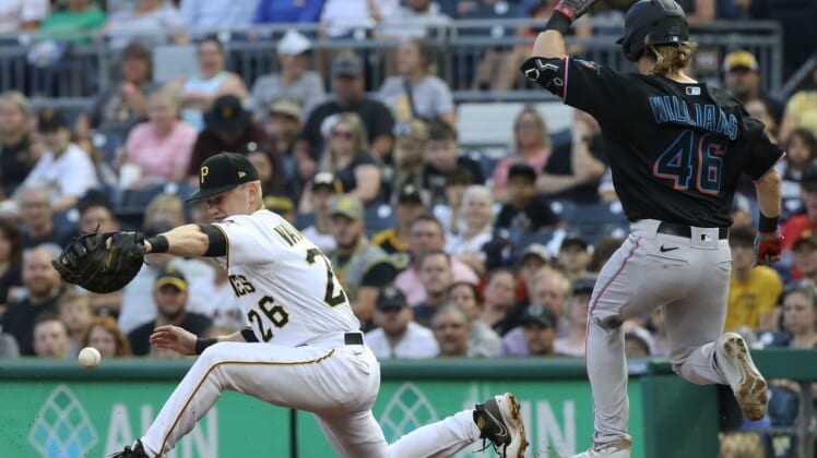 Jul 23, 2022; Pittsburgh, Pennsylvania, USA;  Pittsburgh Pirates first baseman Josh VanMeter (26) drops a throw at first base allowing Miami Marlins left fielder Luke Williams  (46) to safely reach base on an error during the third inning at PNC Park. Mandatory Credit: Charles LeClaire-USA TODAY Sports