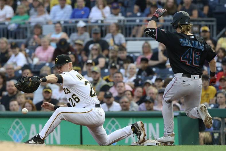Jul 23, 2022; Pittsburgh, Pennsylvania, USA;  Pittsburgh Pirates first baseman Josh VanMeter (26) drops a throw at first base allowing Miami Marlins left fielder Luke Williams  (46) to safely reach base on an error during the third inning at PNC Park. Mandatory Credit: Charles LeClaire-USA TODAY Sports