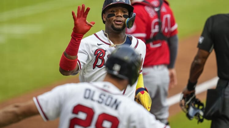 Jul 23, 2022; Cumberland, Georgia, USA; Atlanta Braves right fielder Ronald Acuna Jr. (13) reacts with first baseman Matt Olson (28) after scoring a run against the Los Angeles Angels during the first inning at Truist Park. Mandatory Credit: Dale Zanine-USA TODAY Sports