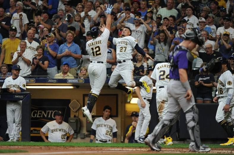 Jul 23, 2022; Milwaukee, Wisconsin, USA; Milwaukee Brewers right fielder Hunter Renfroe (12) celebrates with shortstop Willy Adames (27) after hitting a home run against Colorado Rockies in the fourth inning at American Family Field. Mandatory Credit: Michael McLoone-USA TODAY Sports