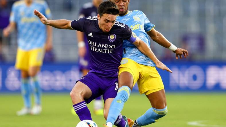 Jul 23, 2022; Orlando, Florida, USA;  Orlando City midfielder Mauricio Pereyra (10) and Philadelphia Union midfielder Jose Andres Martinez (8) battle for possession in the first half at Exploria Stadium. Mandatory Credit: Nathan Ray Seebeck-USA TODAY Sports