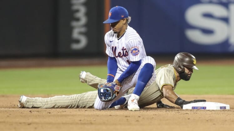 Jul 23, 2022; New York City, New York, USA;  New York Mets shortstop Francisco Lindor (12) holds onto the ball after a pick off attempt against San Diego Padres right fielder Nomar Mazara (16) in the fifth inning at Citi Field. Mandatory Credit: Wendell Cruz-USA TODAY Sports