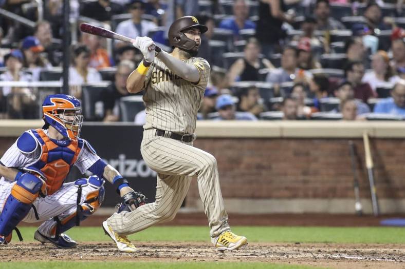 Jul 23, 2022; New York City, New York, USA;  San Diego Padres first baseman Eric Hosmer (30) hits a single against the New York Mets in the fifth inning at Citi Field. Mandatory Credit: Wendell Cruz-USA TODAY Sports