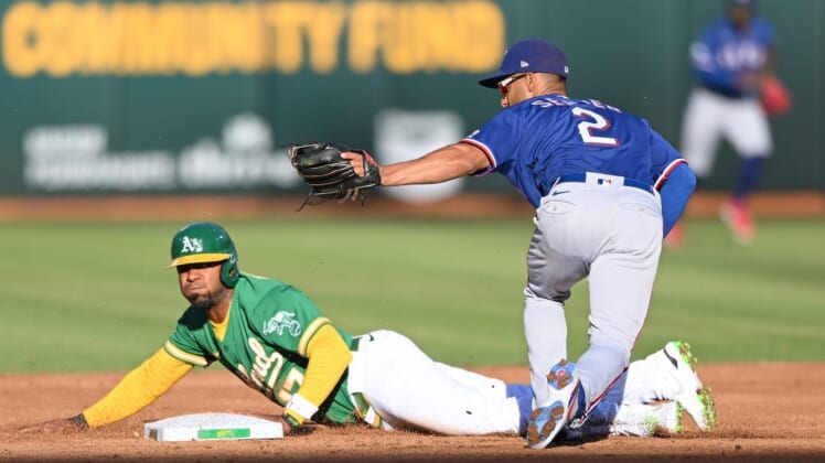Jul 23, 2022; Oakland, California, USA; Texas Rangers second baseman Marcus Semien (2) tags out Oakland Athletics shortstop Elvis Andrus (17) on a steal attempt during the second inning at RingCentral Coliseum. Mandatory Credit: Robert Edwards-USA TODAY Sports