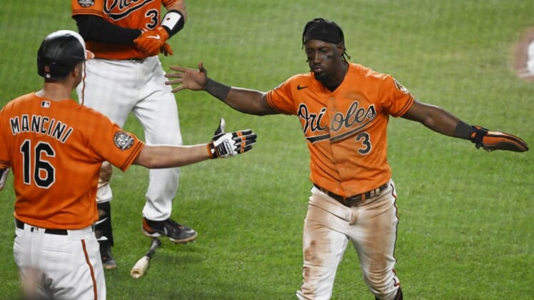 Jul 23, 2022; Baltimore, Maryland, USA;  Baltimore Orioles shortstop Jorge Mateo (3) celebrates with designated hitter Trey Mancini (16) after scoring a run against the New York Yankees during the seventh inning at Oriole Park at Camden Yards. Mandatory Credit: James A. Pittman-USA TODAY Sports