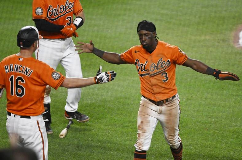Jul 23, 2022; Baltimore, Maryland, USA;  Baltimore Orioles shortstop Jorge Mateo (3) celebrates with designated hitter Trey Mancini (16) after scoring a run against the New York Yankees during the seventh inning at Oriole Park at Camden Yards. Mandatory Credit: James A. Pittman-USA TODAY Sports