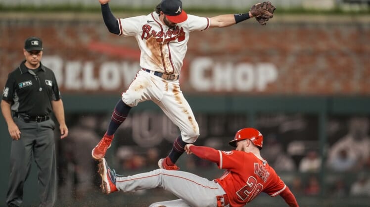 Jul 23, 2022; Cumberland, Georgia, USA; Atlanta Braves shortstop Dansby Swanson (7) has to jump over a sliding Los Angeles Angels first baseman Jared Walsh (20) during the sixth inning at Truist Park. Mandatory Credit: Dale Zanine-USA TODAY Sports