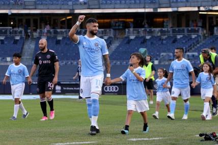 Jul 23, 2022; New York, New York, USA; New York City FC midfielder Valentin Castellanos (11) reacts as he is escorted onto the pitch by a young fan before a match against Inter Miami CF at Yankee Stadium. Mandatory Credit: Brad Penner-USA TODAY Sports