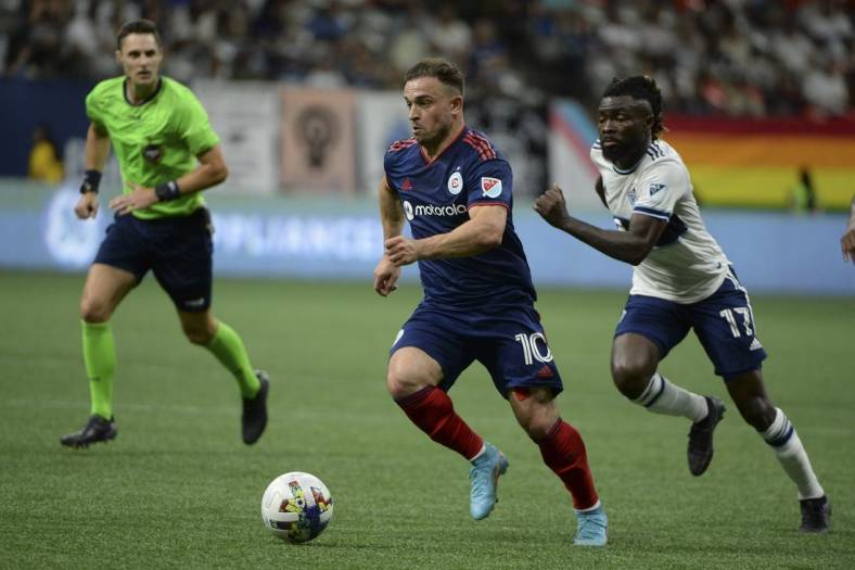 Jul 23, 2022; Vancouver, British Columbia, CAN;  Chicago Fire FC midfielder Xherdan Shaqiri (10) dribbles the ball against Vancouver Whitecaps FC midfielder Leonard Owusu (17) during the second half at BC Place. Mandatory Credit: Anne-Marie Sorvin-USA TODAY Sports