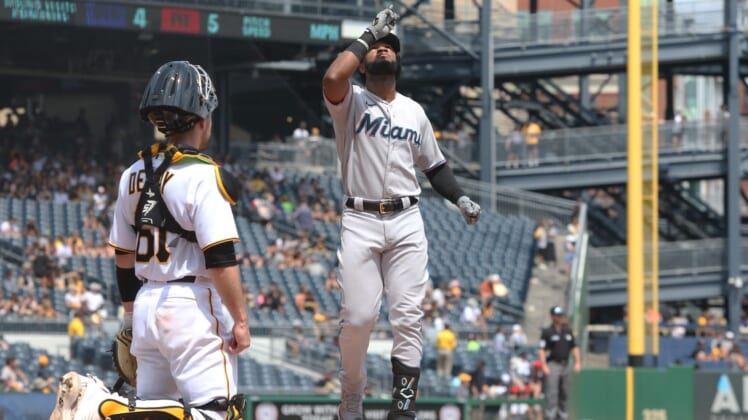 Jul 24, 2022; Pittsburgh, Pennsylvania, USA;  Miami Marlins right fielder Bryan De La Cruz (14) crosses home plate on a solo home run against the Pittsburgh Pirates during the fifth inning at PNC Park. Mandatory Credit: Charles LeClaire-USA TODAY Sports