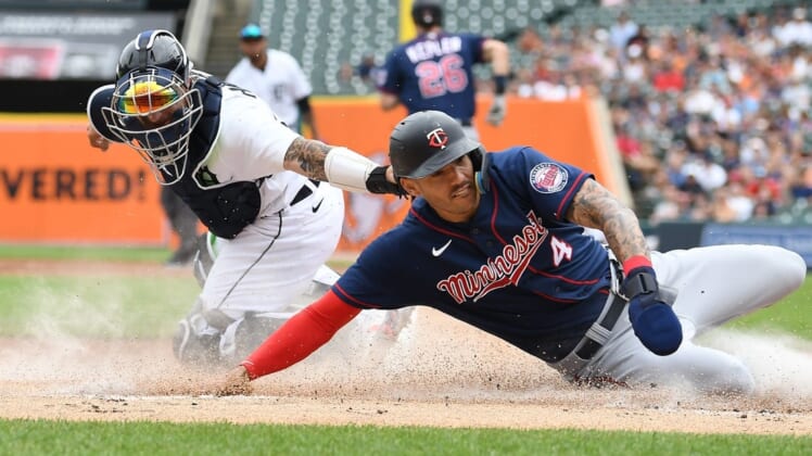 Jul 24, 2022; Detroit, Michigan, USA; Minnesota Twins shortstop Carlos Correa (4) slides safely into home plate ahead of the tag of Detroit Tigers catcher Eric Haase (13) on a fielder s choice hit by right fielder Max Kepler (not pictured) during the first inning at Comerica Park. Mandatory Credit: Lon Horwedel-USA TODAY Sports