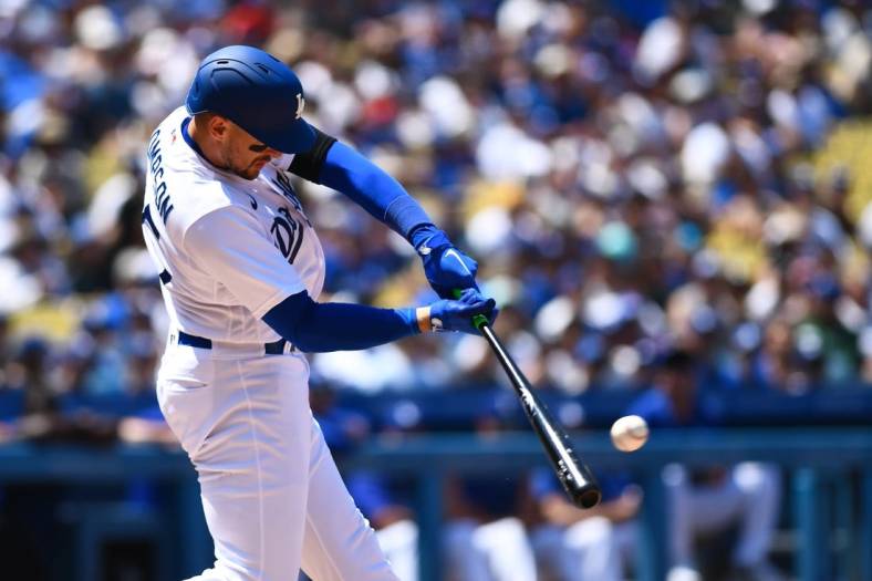 Jul 24, 2022; Los Angeles, California, USA; Los Angeles Dodgers right fielder Trayce Thompson (25) hits a single and earns a RBI against the San Francisco Giants during the third inning at Dodger Stadium. Mandatory Credit: Jonathan Hui-USA TODAY Sports