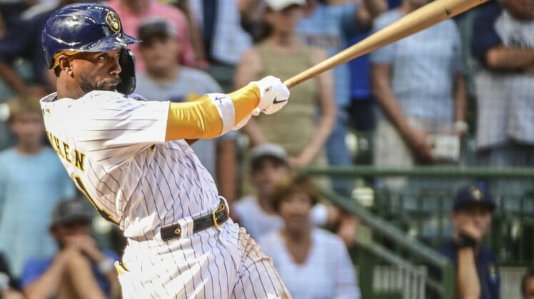 Jul 24, 2022; Milwaukee, Wisconsin, USA; Milwaukee Brewers designated hitter Andrew McCutchen (24) hits a RBI double in the eighth inning against the Colorado Rockies at American Family Field. Mandatory Credit: Benny Sieu-USA TODAY Sports