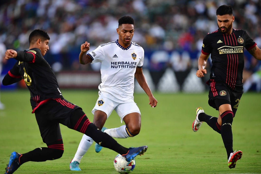 Jul 24, 2022; Carson, California, USA; Los Angeles Galaxy midfielder Rayan Raveloson (6) moves the ball against Atlanta United defender Alan Franco (6) and defender Juan Jose Purata (22) during the first half at Dignity Health Sports Park. Mandatory Credit: Gary A. Vasquez-USA TODAY Sports