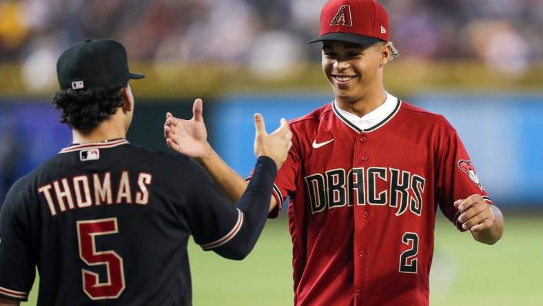 Diamondbacks Draft Druw Jones, right, shakes hands with Arizona Diamondbacks center fielder Alek Thomas (5), left, after throwing the opening pitch before the game against the Washington Nationals at Chase Field on Saturday, July 23, 2022, in Phoenix.

Uscp 7lzxvqcipg7dt8x01rk2 Original