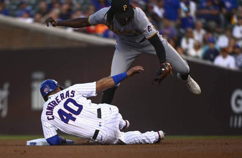 Jul 25, 2022; Chicago, Illinois, USA; Pittsburgh Pirates shortstop Oneil Cruz (top) tags out Chicago Cubs catcher Willson Contreras (40) during the first inning at Wrigley Field. Mandatory Credit: Matt Marton-USA TODAY Sports